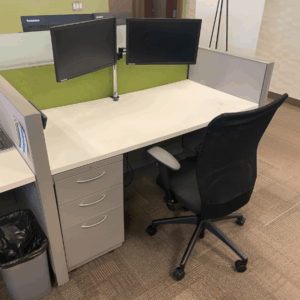 Allsteel cubicle in grey, white and green and a mesh desk chair